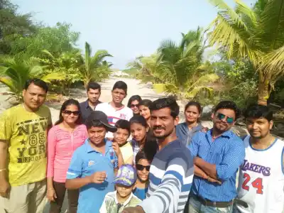 Tour Group on palm-lined beach path in Tarkarli Malvan