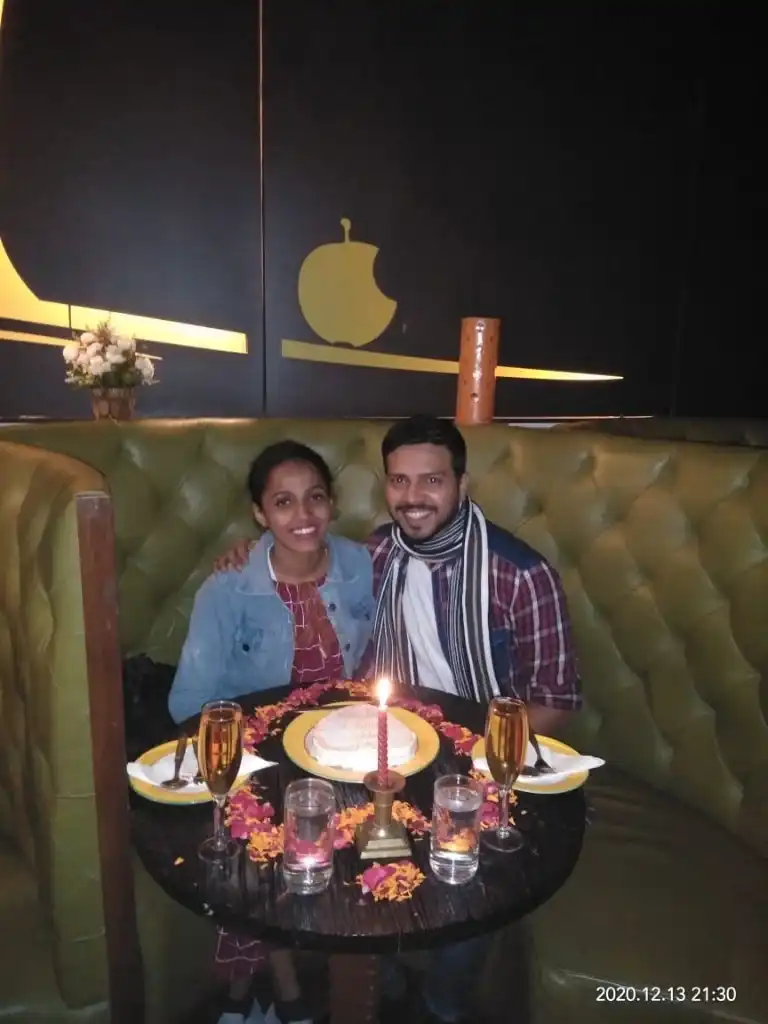 Couple celebrating with cake in booth