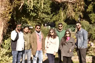 Tour Group posing outdoors amidst lush green park foliage in North East