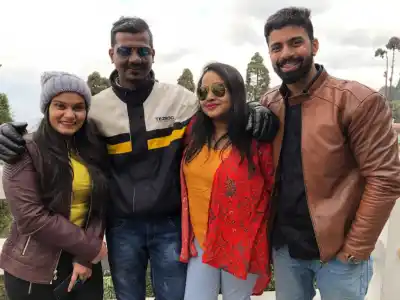 Group of friends posing closely on viewpoints in North East tour