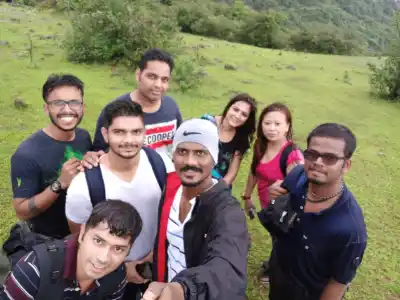 Tour Group selfie on green hills of Visapur Fort Trek