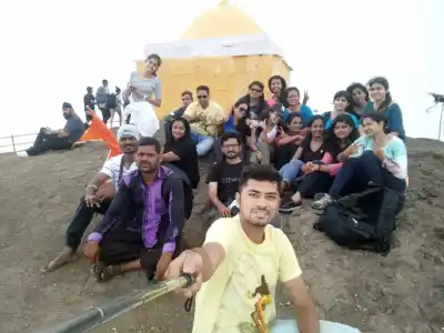 Tour Group selfie at Kalsubai Peak summit yellow dome temple