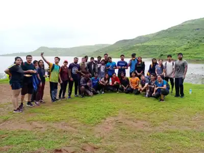 Tour Group posing next to lake on Garbett Trek
