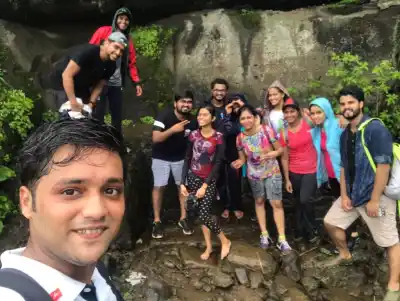 Tour Group selfie under rock overhang on Visapur Fort Trek