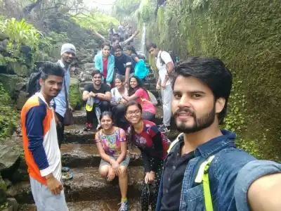 Tour Group selfie on cascading stone steps on Visapur Fort Trek