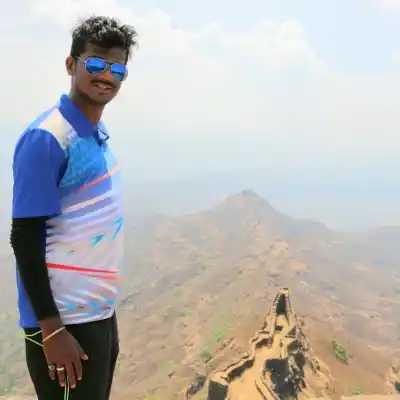 Trekker looking at spectacular historic fort walls on Rajgad to Torana Trek